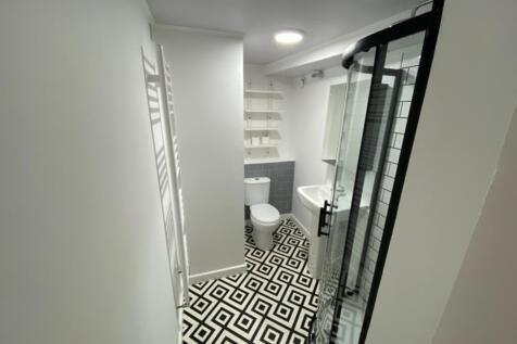 Modern bathroom suite featuring a stylish showe...
