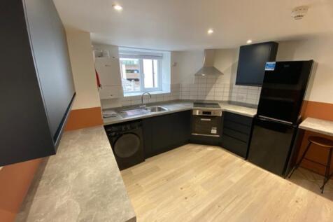 A modern kitchen featuring stylish cabinetry, a...