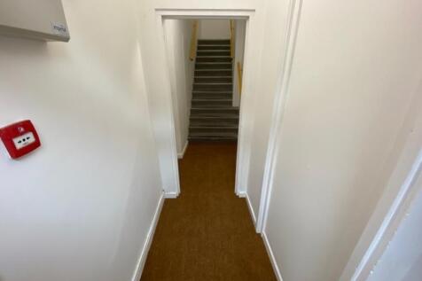 A well-maintained staircase leading to upper le...