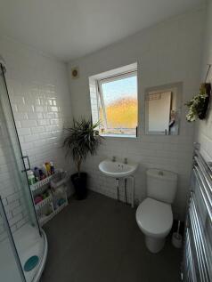 Bright and modern bathroom suite featuring a sp...