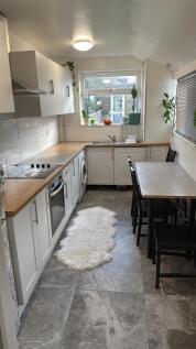 This modern kitchen features a spacious layout ...