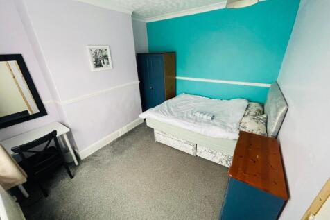 Cozy double bedroom featuring a comfortable bed...