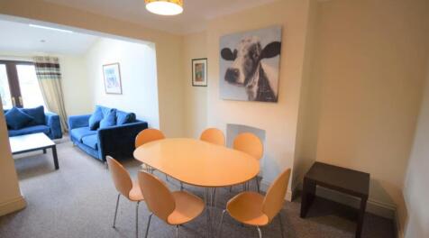 A cozy living room featuring a bright and invit...
