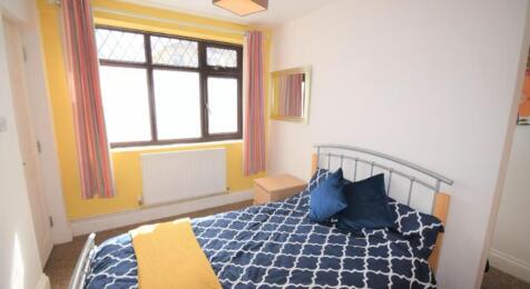 Bright and inviting double bedroom featuring la...