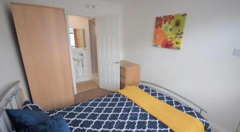 Cozy double bedroom featuring a vibrant floral ...