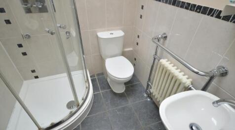 A modern bathroom featuring a sleek shower encl...
