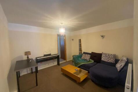 A cozy living room featuring a spacious layout ...