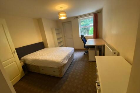 Spacious double bedroom featuring a comfortable...