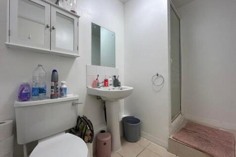 A clean and functional bathroom with a shower, ...