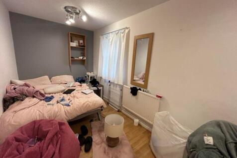 A cozy double bedroom with natural light and pe...