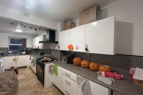 A spacious and well-lit kitchen with ample stor...