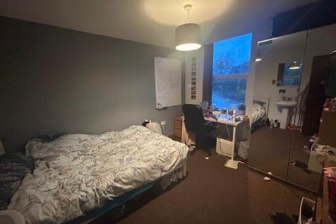 A cozy and inviting double bedroom with ample n...