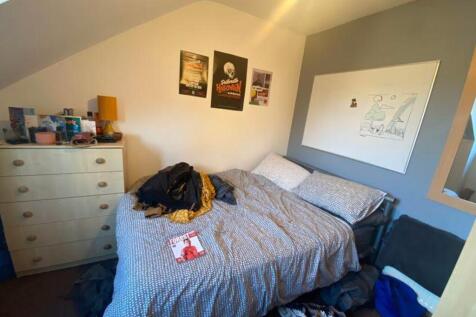 A cozy double bedroom with personal touches and...
