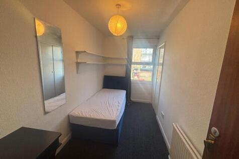 This inviting double bedroom features a comfort...