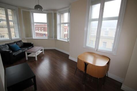 Bright and inviting living room featuring large...