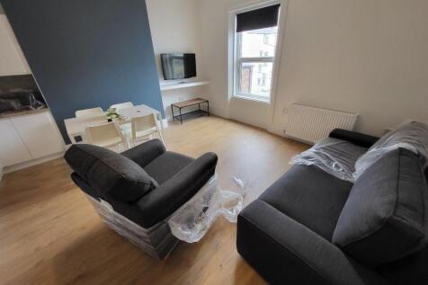A bright and modern living room featuring styli...