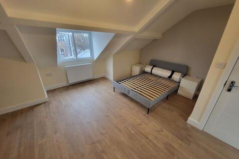 A bright and spacious double bedroom featuring ...