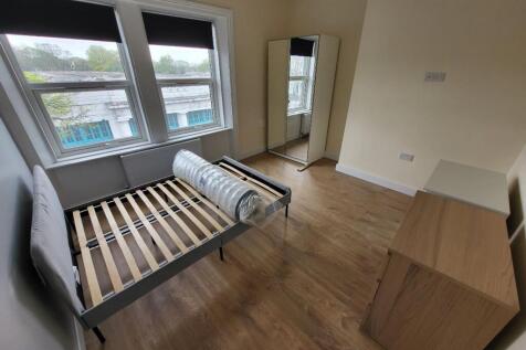 This inviting double bedroom features large win...