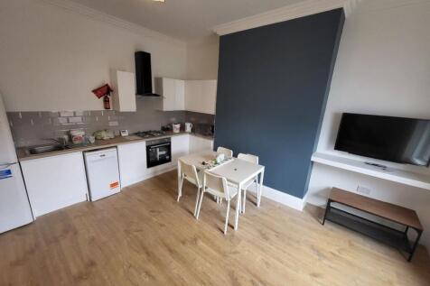 Spacious kitchen featuring modern appliances, a...