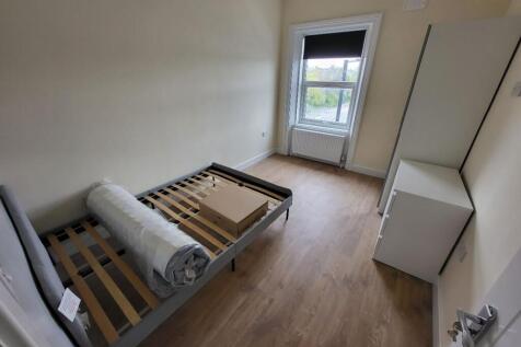 A bright and inviting double bedroom featuring ...