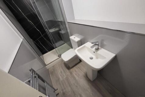 A modern bathroom featuring a sleek design with...