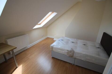 A charming double bedroom featuring a cozy bed ...