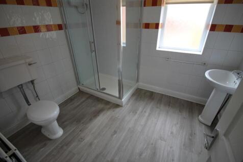 A modern bathroom featuring a spacious shower, ...