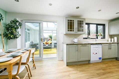 This modern kitchen features a spacious layout ...