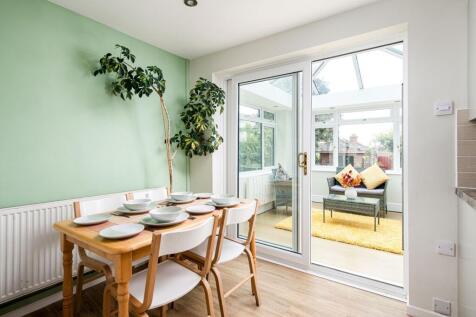 Bright and inviting kitchen area with a dining ...