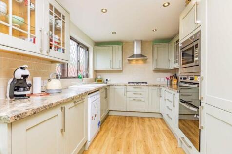 This modern kitchen features stylish cabinetry ...