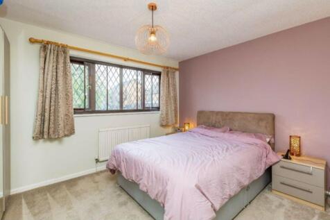 This cozy double bedroom features a comfortable...