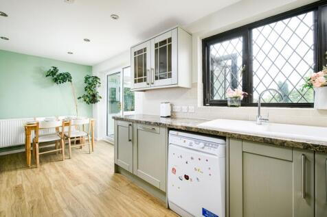 Bright and modern kitchen featuring spacious co...
