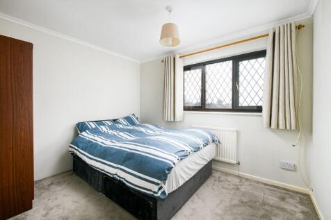 A cozy double bedroom featuring a spacious bed ...