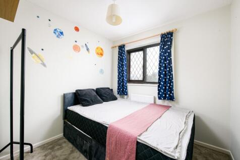 This inviting double bedroom features a cozy la...