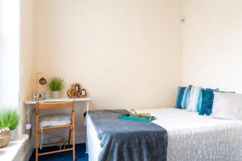 This charming double bedroom offers a cozy and ...