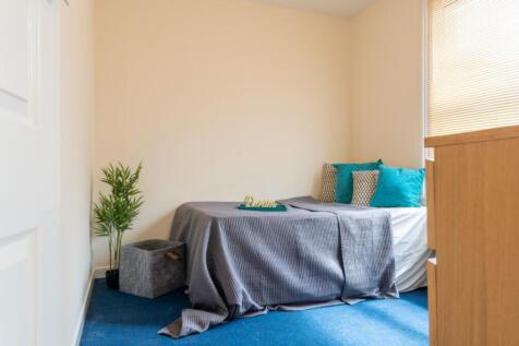 This inviting double bedroom features a cozy la...