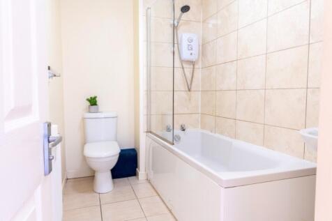 This well-maintained bathroom features a modern...