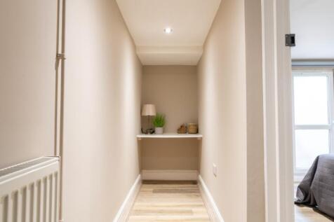 A welcoming hallway featuring clean lines and w...