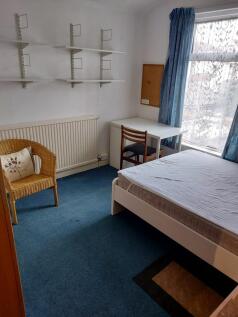 A cozy double bedroom featuring a comfortable b...