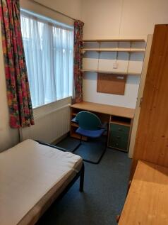 Cozy double bedroom featuring a comfortable bed...