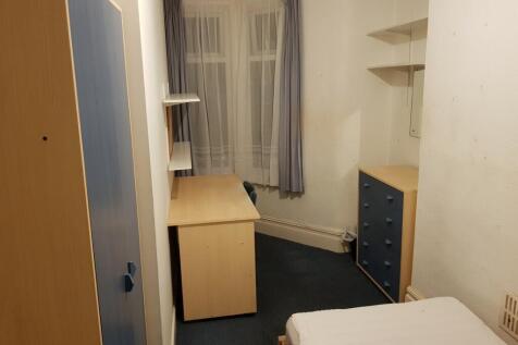 Cozy double bedroom featuring a large window th...