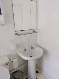 Bright and functional bathroom featuring a clea...