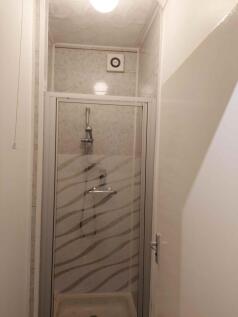 A modern and well-maintained shower area, featu...