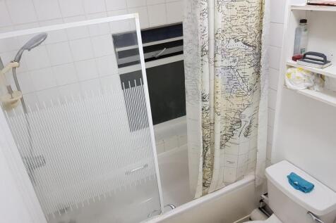 A well-maintained bathroom featuring a bath wit...