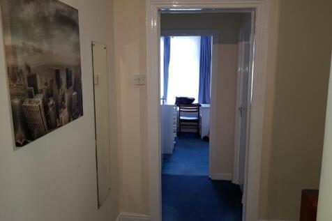 A welcoming hallway featuring a cozy carpet, wi...