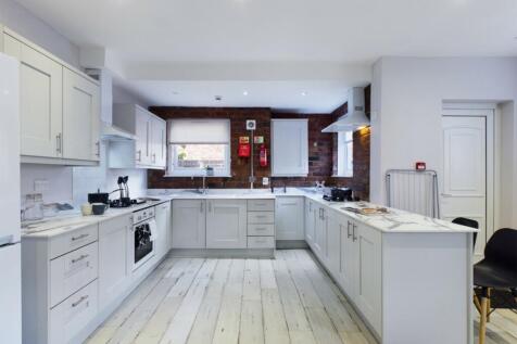 A spacious and modern kitchen with stylish fini...