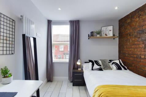 A stylish and bright double bedroom featuring m...
