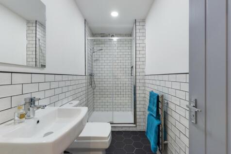 A modern and stylish bathroom featuring a spaci...
