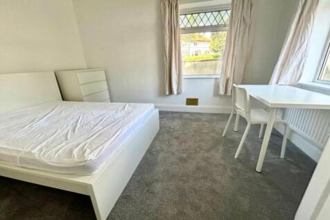 A bright and spacious double bedroom with a mod...