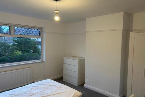 A bright and spacious double bedroom with lovel...